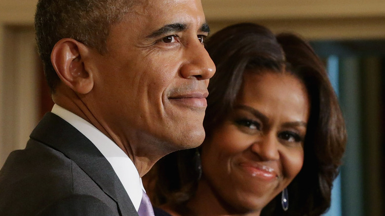 Michelle Obama looking at Barack smiling