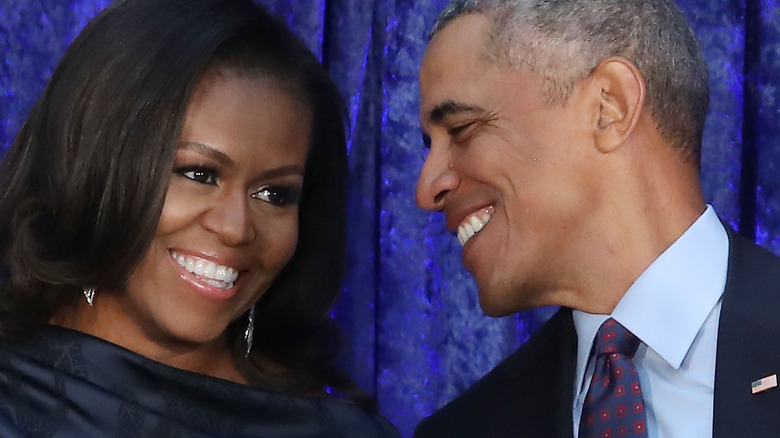 Barack, Michelle Obama laughing with each other