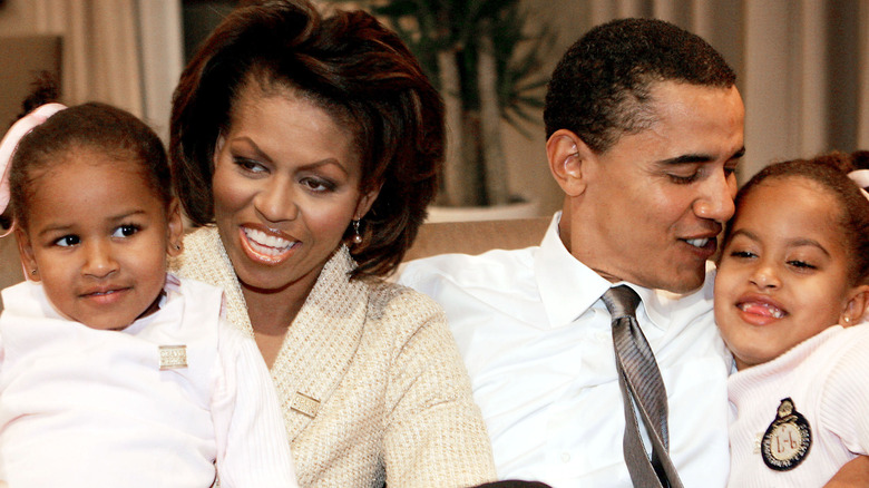 Michelle Barack Obama cuddling daughters Sasha and Malia