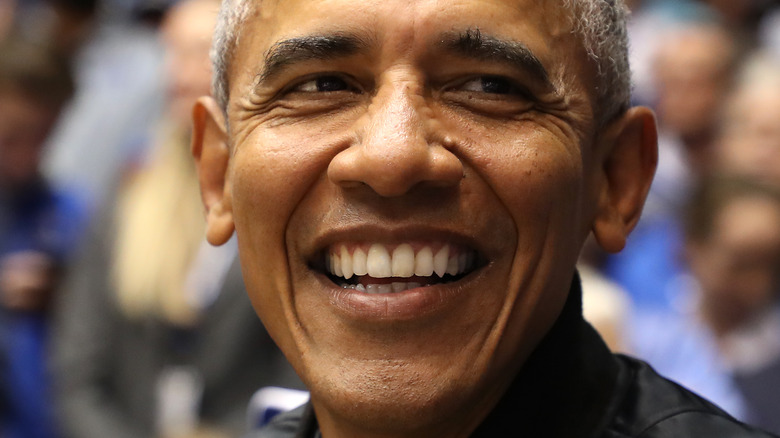 Barack Obama laughing at camera grey hair