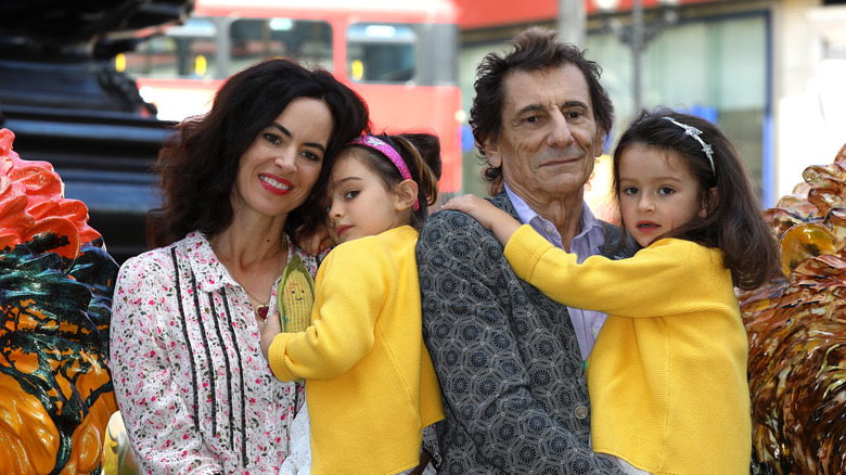 Ronnie Wood, Sally Humphreys holding twins