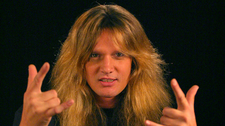 Sebastian Bach making devil horns hand gesture