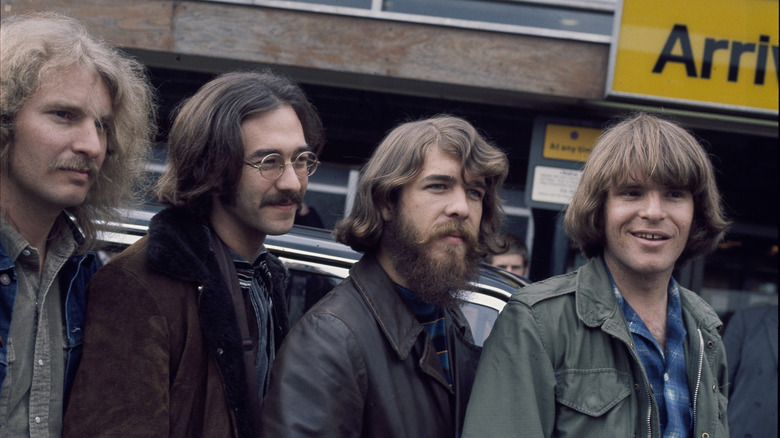 Credence Clearwater Revival members pose near car