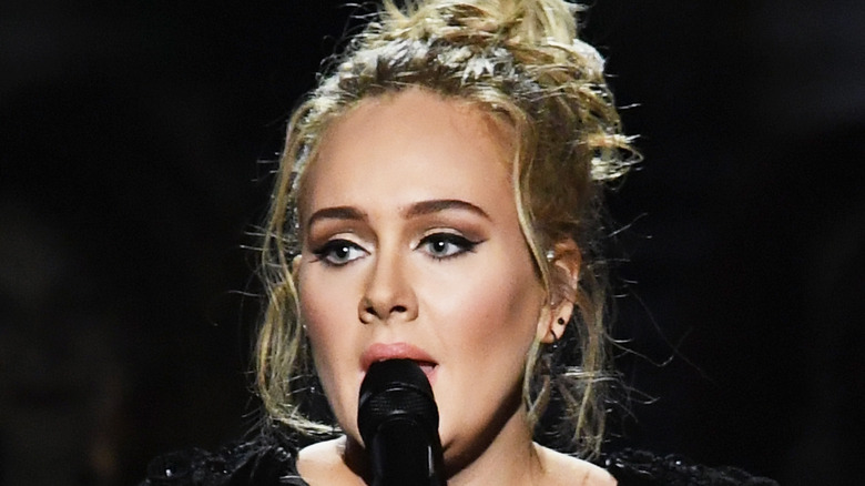 Adele singing while wearing black