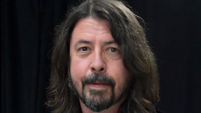 Dave Grohl in front of a black curtain