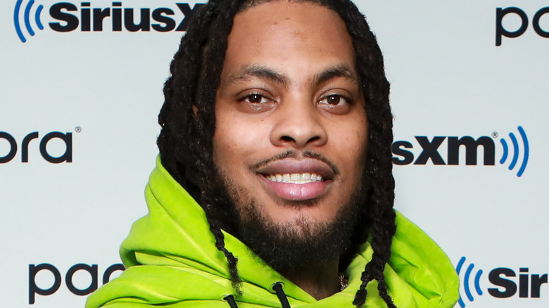 Waka Flocka wearing a lime green hoodie