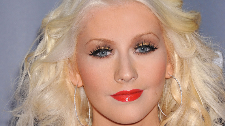 Christina Aguilera smiling with red lipstick 