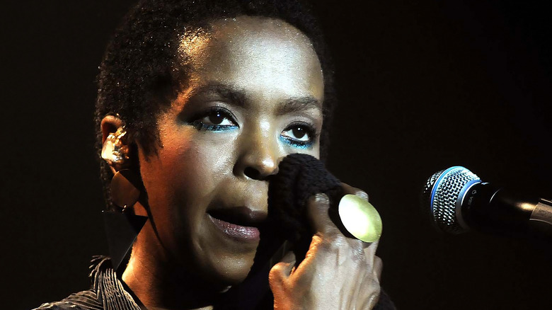 Lauryn Hill wiping face with fabirc