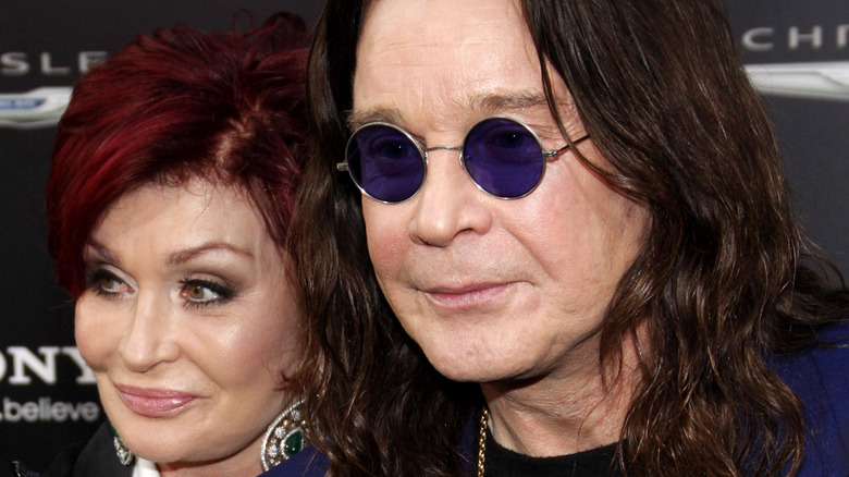 Sharon Osbourne and Ozzy Osbourne looking away from the camera