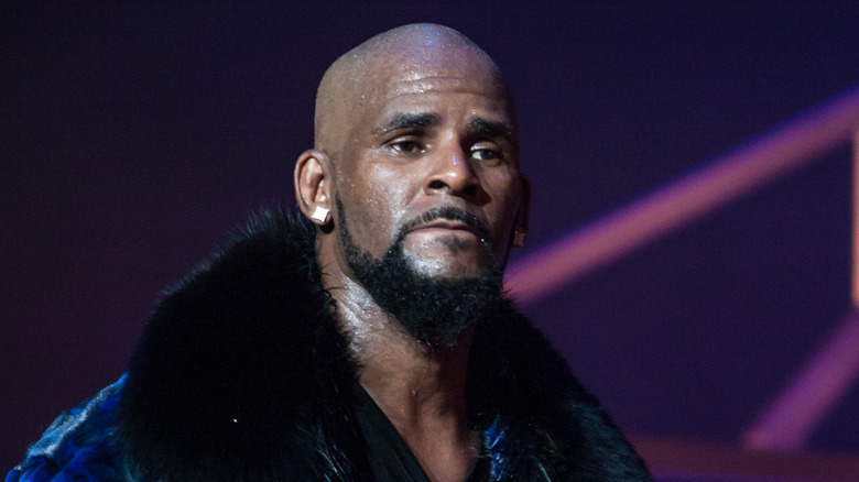 R Kelly sweating on stage and looking into distance