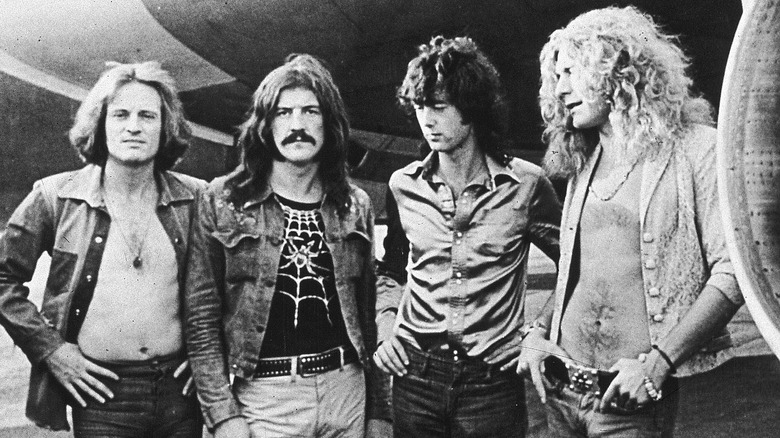 Led Zeppelin in front of a plane