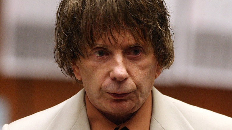 Phil Spector wearing an off-white suit