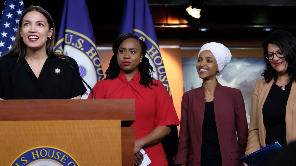 Rashida Tlaib, Alexandria Ocasio-Cortez, Ilhan Omar, Ayanna Pressley smiling