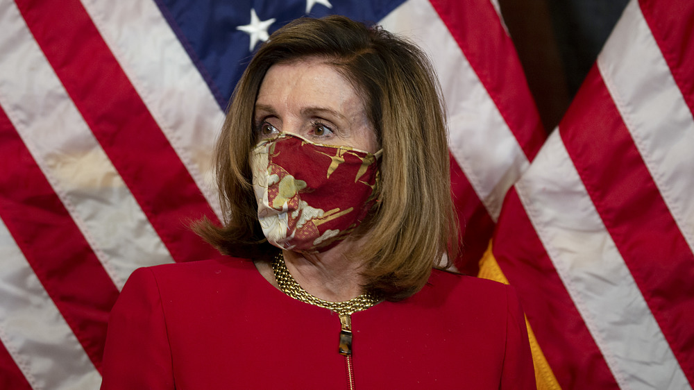 Nancy Pelosi in front of American flag