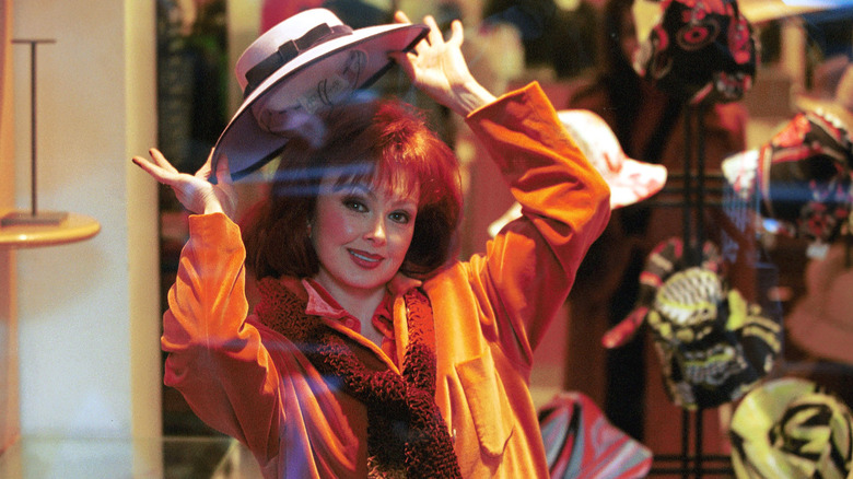 Naomi Judd holding hat