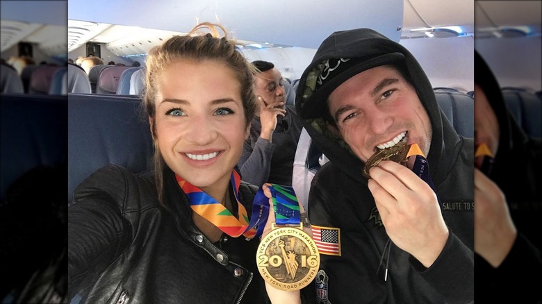 Naomie Olindo and Craig Conover flaunting their medals