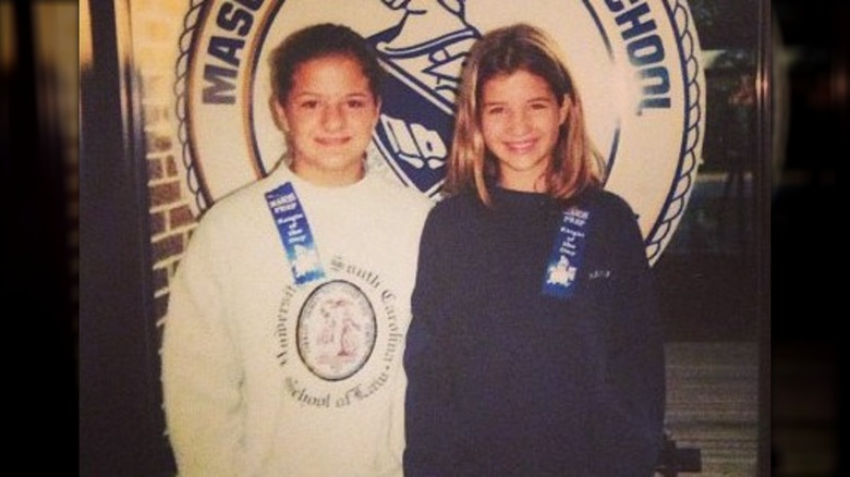 Young Naomie Olindo posing with a schoolmate