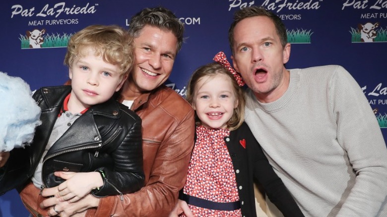 David Burtka and Neil Patrick Harris posing with their kids