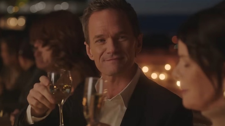 Neil Patrick Harris raising a glass in Uncoupled
