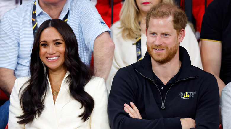 Meghan Markle sitting with Prince Harry