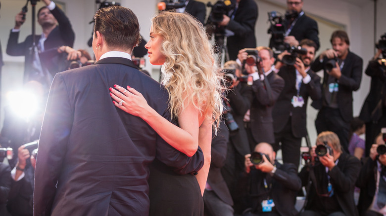 Johnny Depp and Amber Heard with their backs to the camera