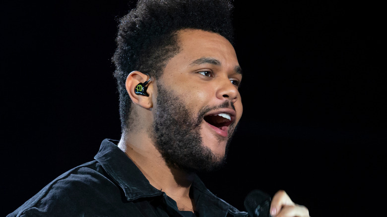 The Weeknd sings on stage