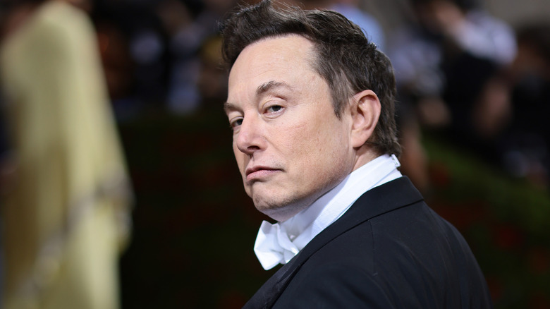 Elon Musk giving side eye in a tux