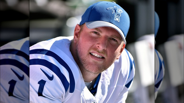 Pat McAfee in blue baseball hat