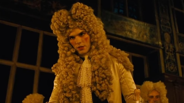 Nicholas Hoult in a big wig, speaking