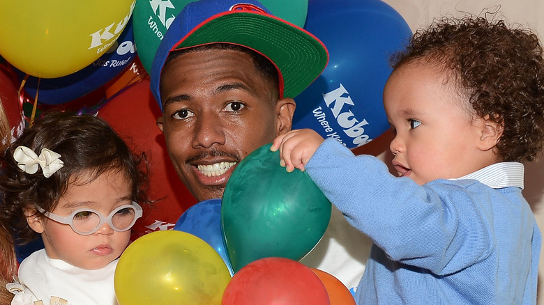 Nick Cannon with kids and balloons