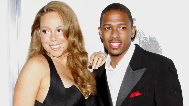 Mariah Carey and Nick Cannon smile in black