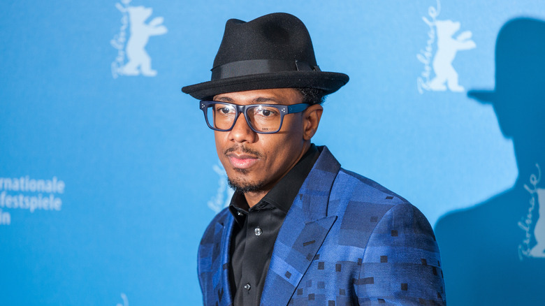 Nick Cannon wearing glasses and fedora