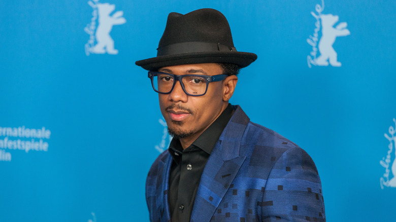 Nick Cannon in hat and glasses