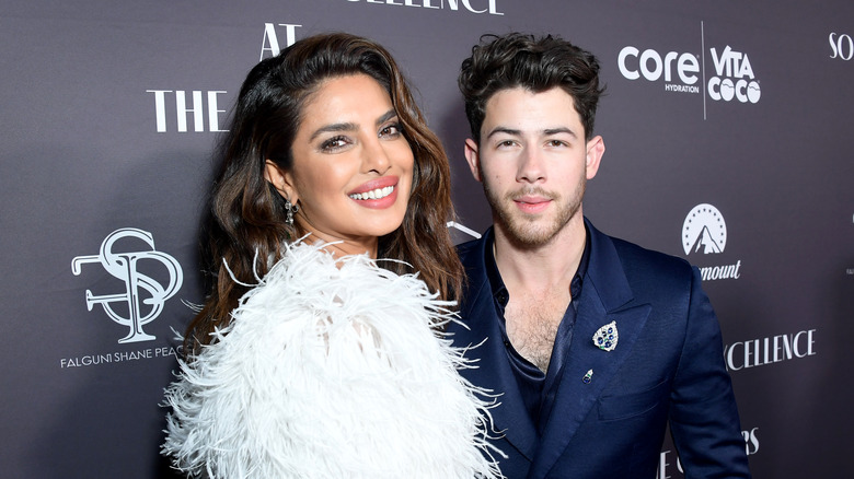 Nick and Priyanka Chopra Jonas pose on the red carpet smiling