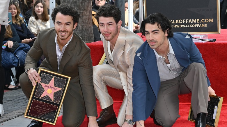 Kevin, Nick and Joe Jonas pose with their Walk of Fame star