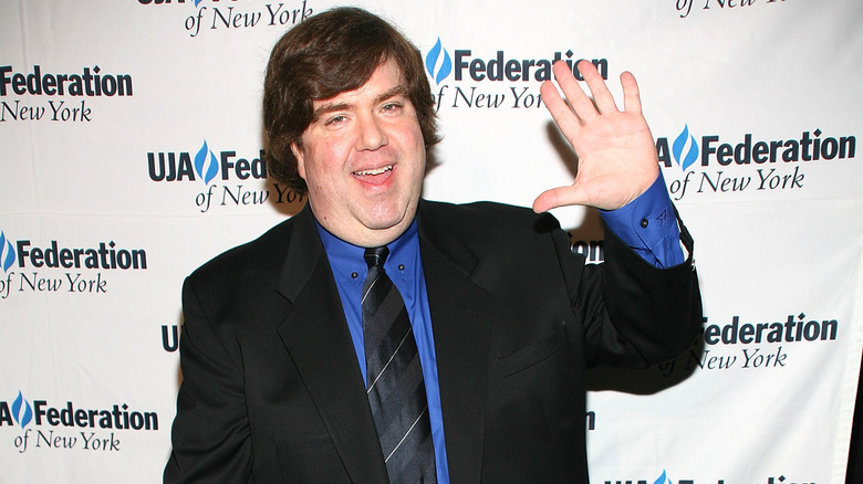 Dan Schneider smiling and waving