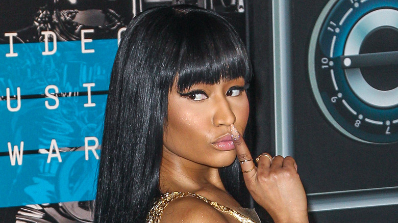 Nicki Minaj with her finger on her lips 