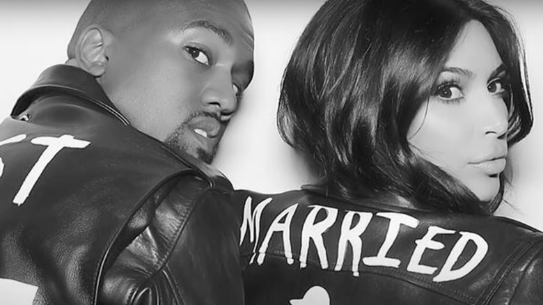 Kim Kardashian and Kanye West wearing "Just Married" jackets