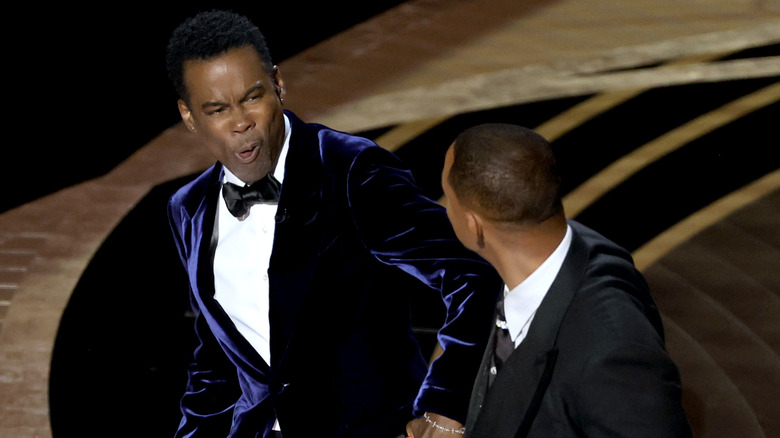 Chris Rock wincing in front of Will Smith