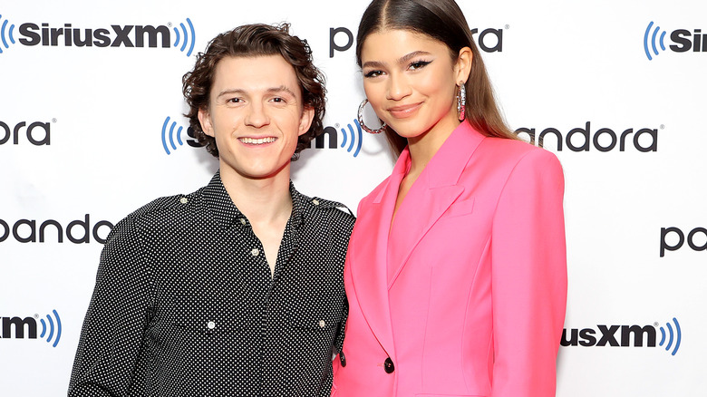 Tom Holland and Zendaya smiling for photo