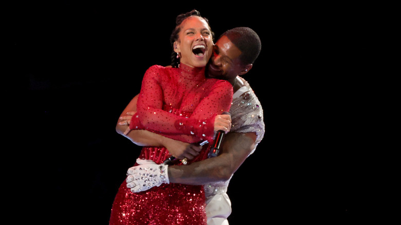 Usher and Alicia Keys hug and laugh on stage