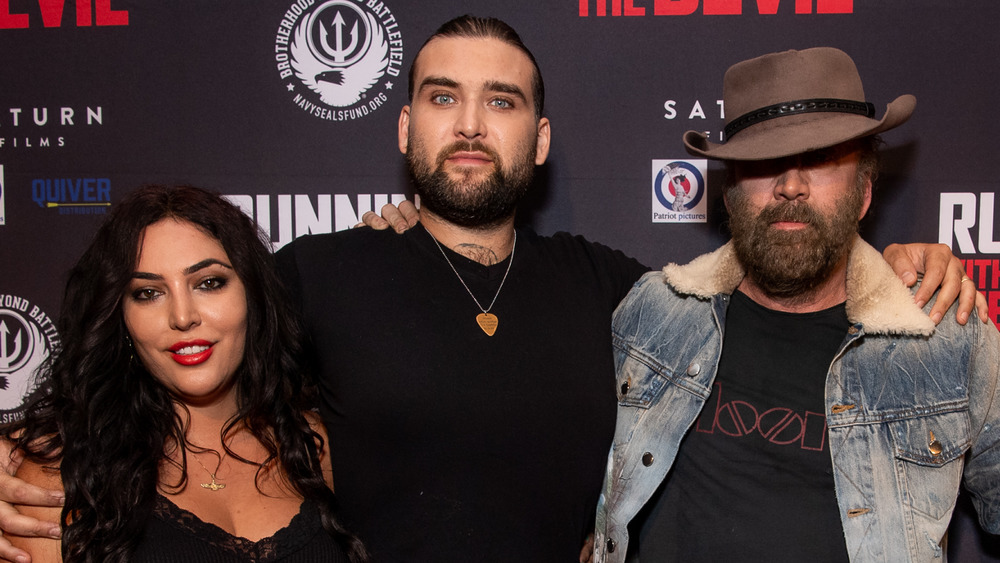 Weston Cage Coppola, his wife, and Nicolas Cage embracing on the red carpet