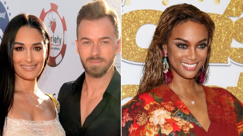 Nikki Bella, Artem Chigvintsev, and Tyra Banks posing