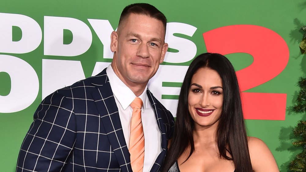 John Cena and Nikki Bella smiling on the red carpet 