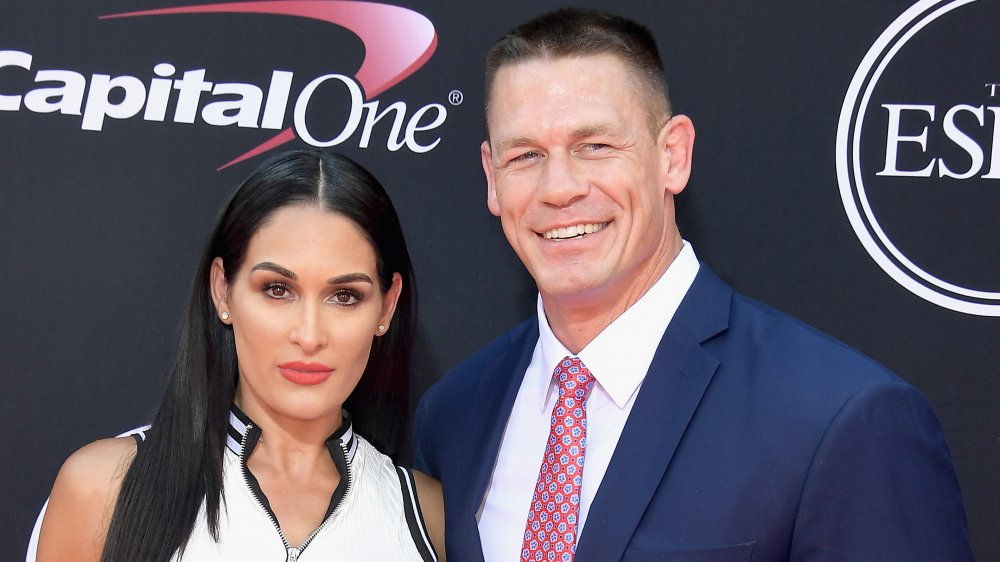 Nikki Bella and John Cena smiling on the red carpet cena