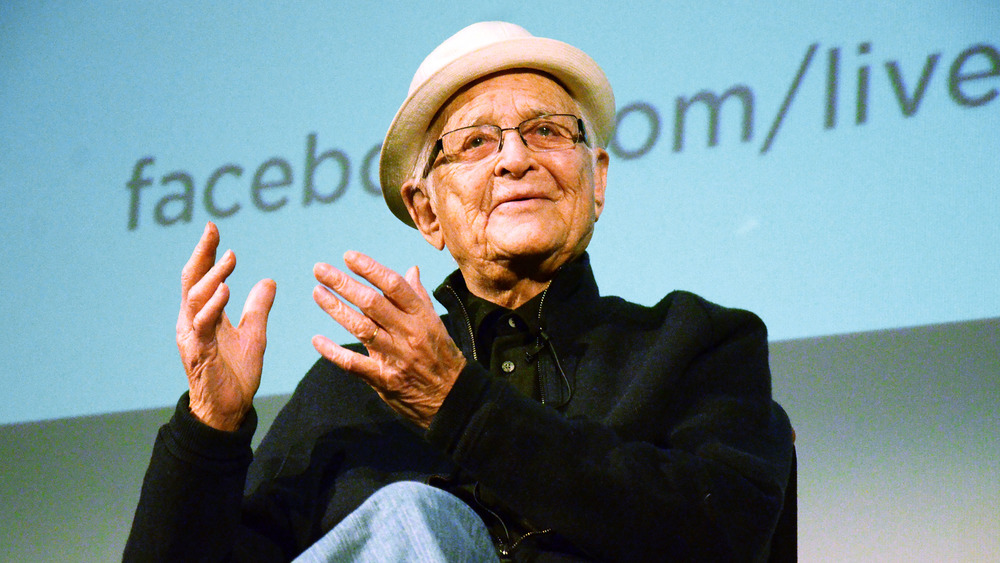 Norman Lear smiling and holding out hands