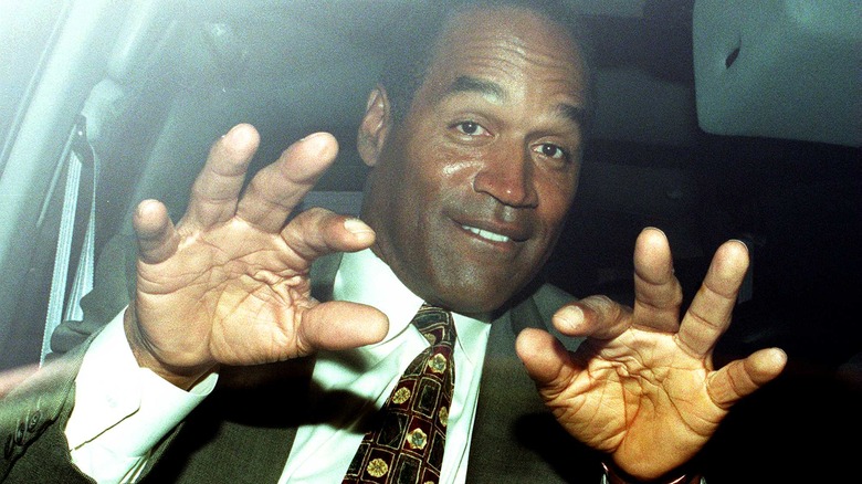 O.J. Simpson holding out hands