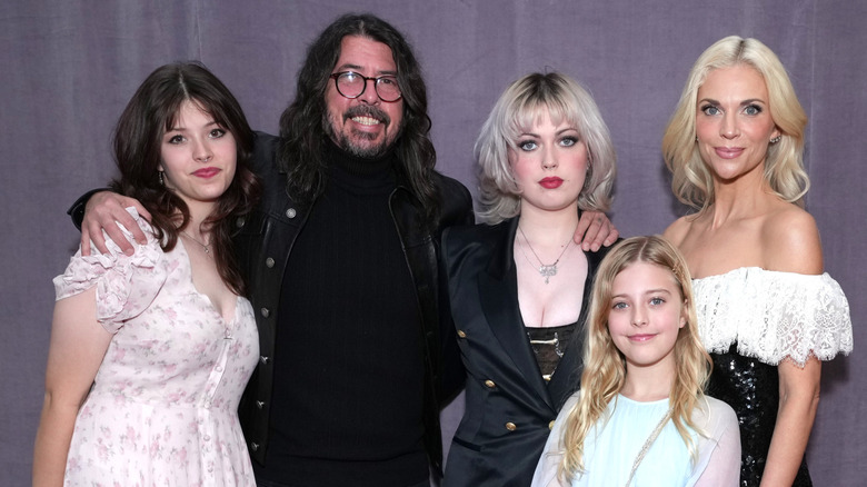 Dave Grohl, Jordyn Blum, and their kids posing on the red carpet.