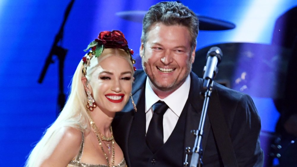 Gwen Stefani and Blake Shelton smiling big after performing on stage together