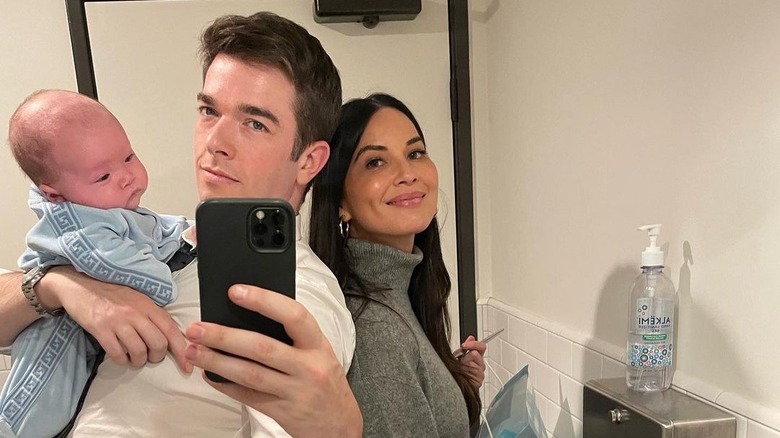 Olivia Munn, John Mulaney, and Malcom pose 